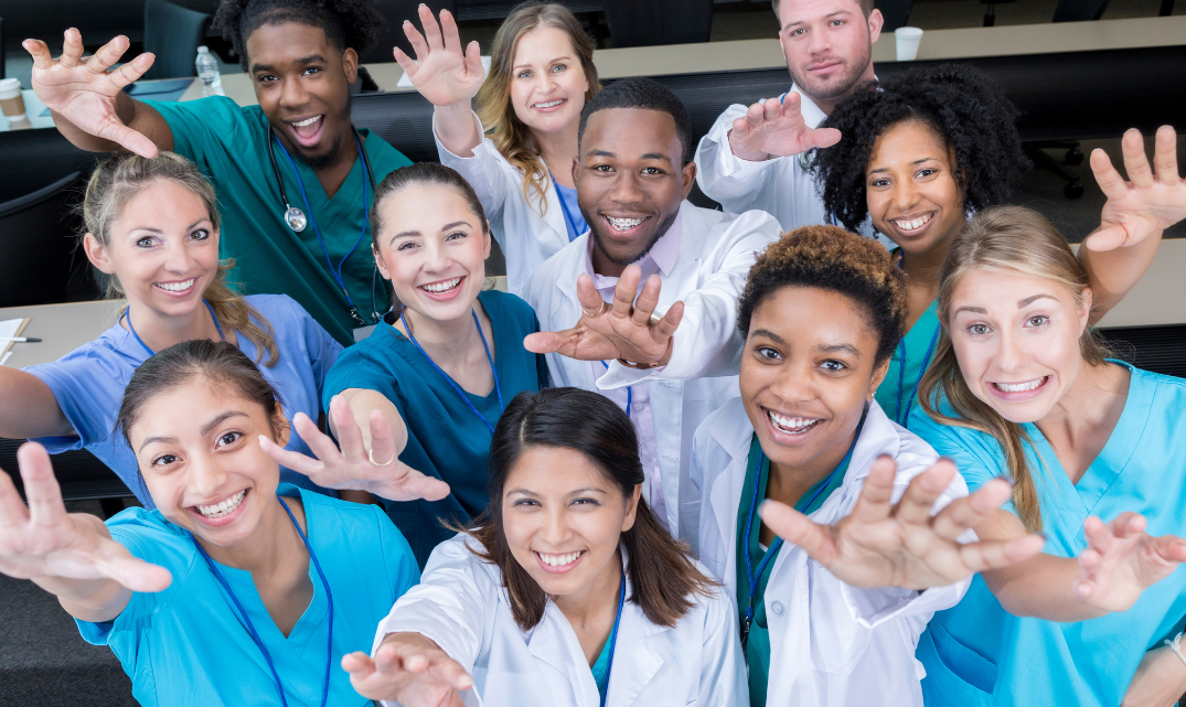 A group of health professionals from many fields reach out to the camera