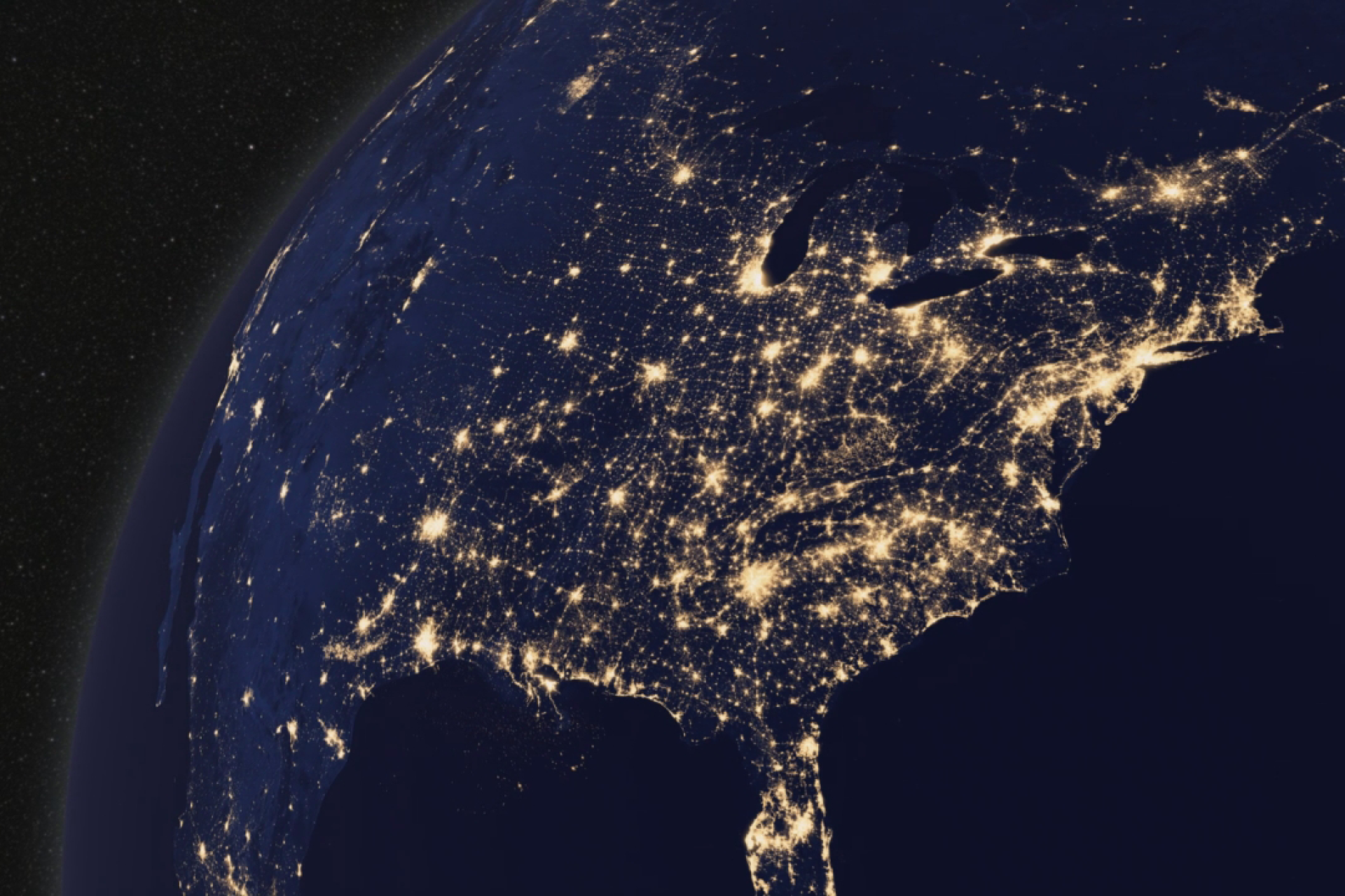 Earth at night from space. Lights across North America sparkle on a dark continent.