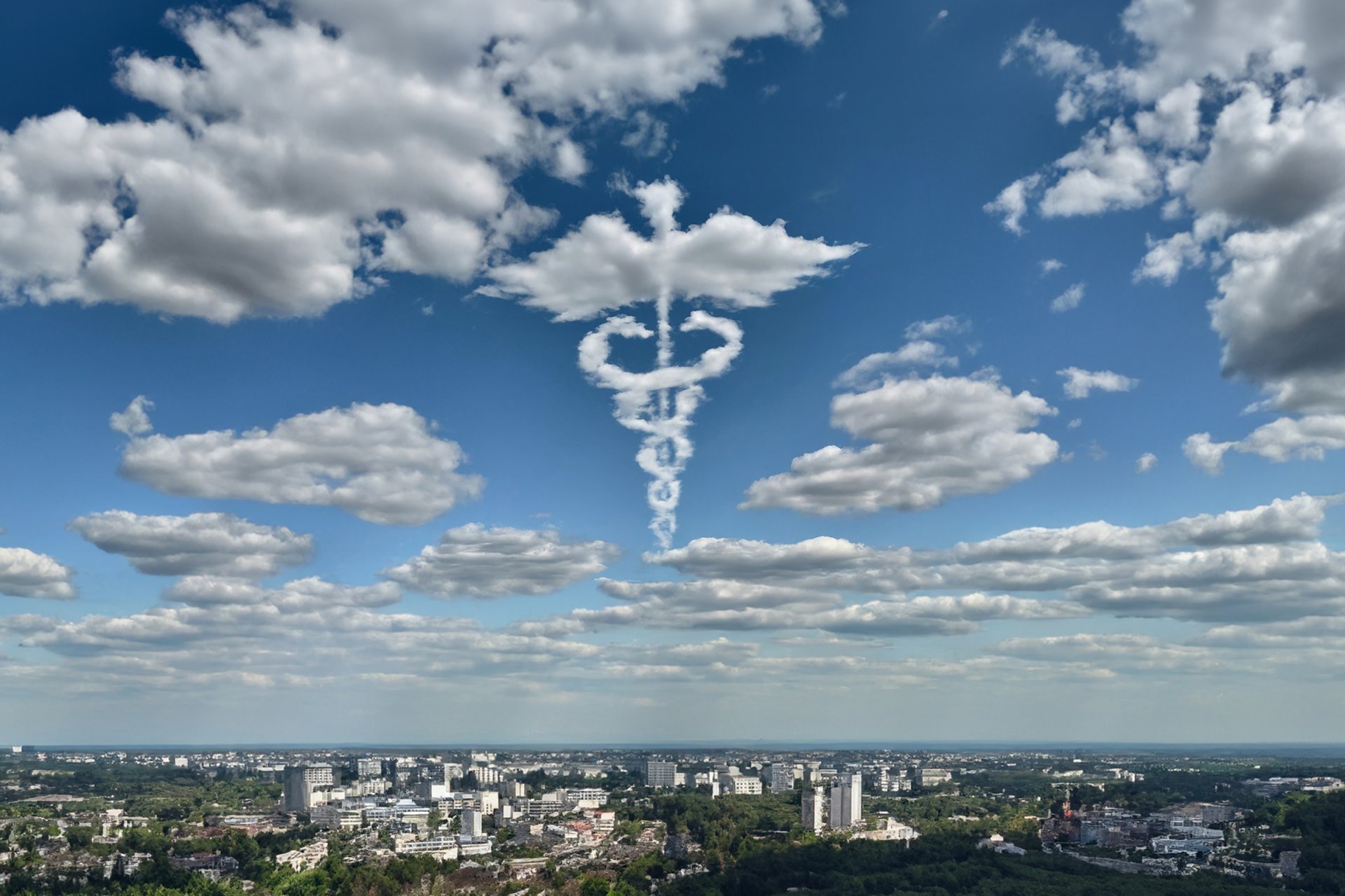 skyline with caduceus symbol in clouds