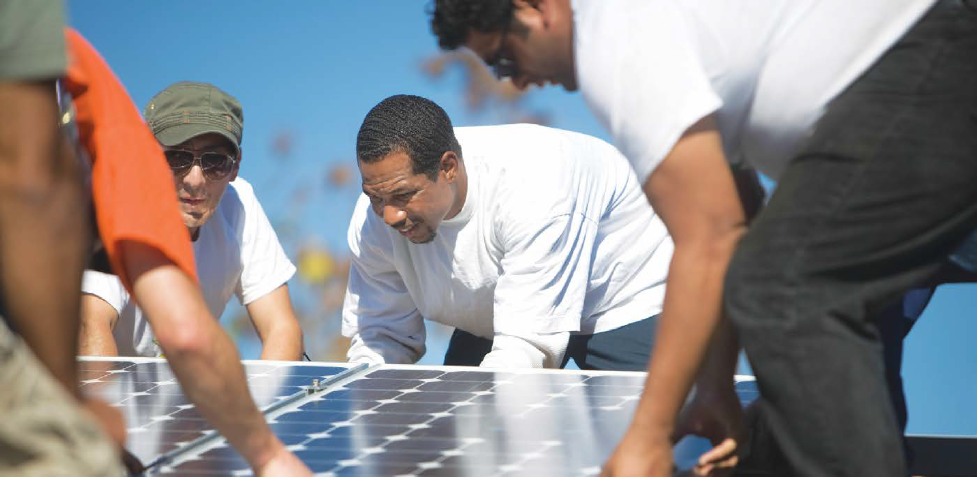 A group of men install solar panels