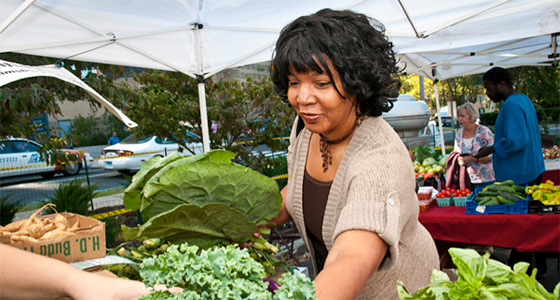 Avon Johnson, director of Connecticut Mental Health Center's inpatient unit shops for fresh greens (Amy Etra)