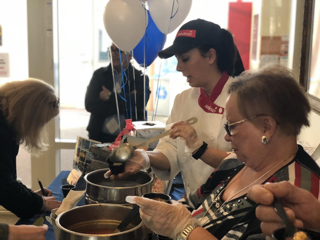 Cassandra and Angela serve seafood soup